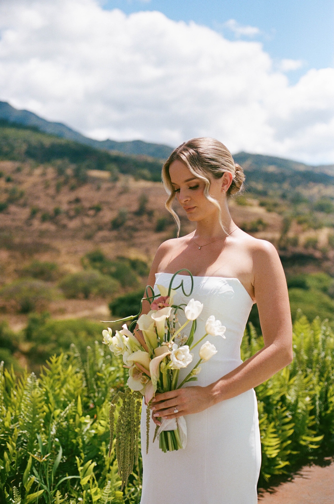 Bride portraits with her looking down towards her bouquet for her Hawaii destination wedding.