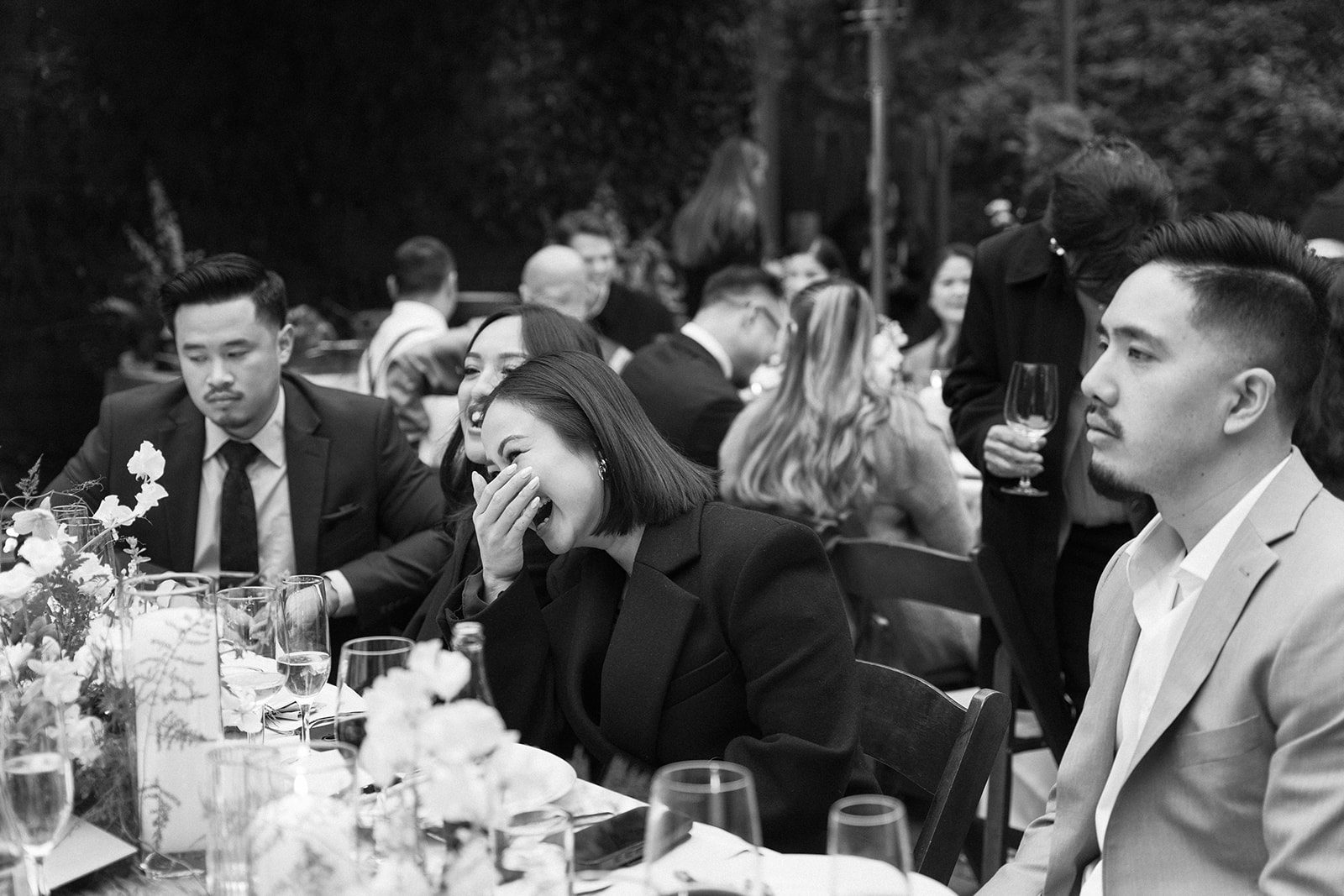 Quests laughing and visiting during a Big Sur wedding reception.