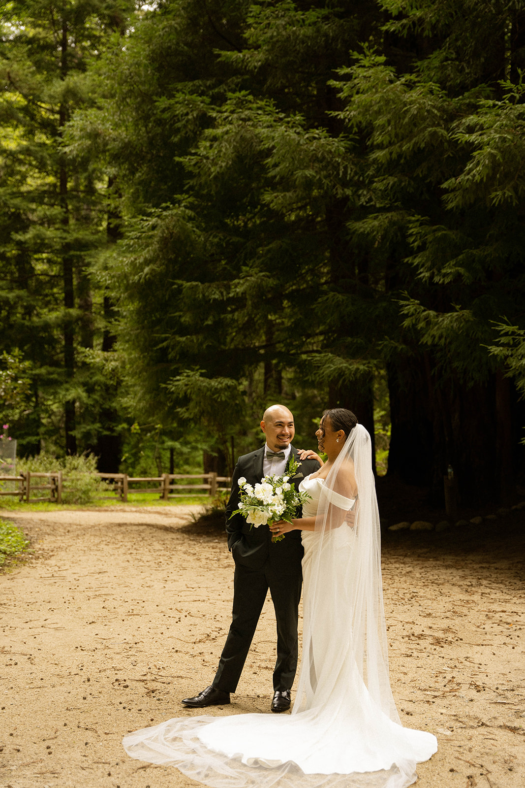 Bride and groom sharing a first look surrounded by towering redwoods at their dreamy Big Sur wedding venue.