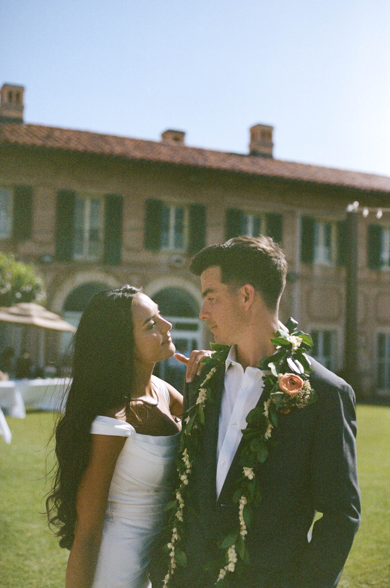 A romantic shot of the couple gazing into each other’s eyes on the lawn of a historic estate, captured by a destination wedding photographer.