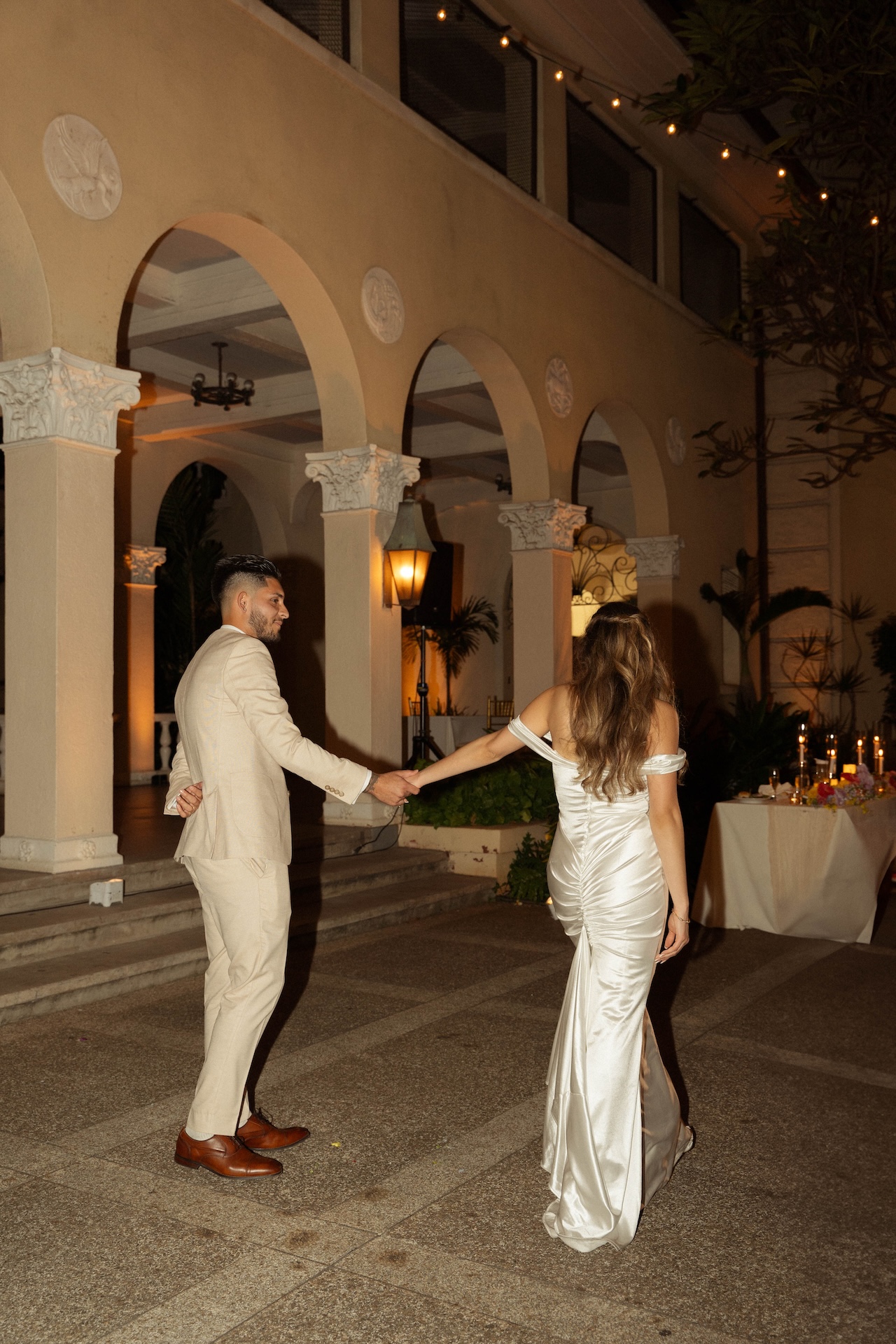 The bride and groom walking onto the dance floor at their wedding for their first dance. 