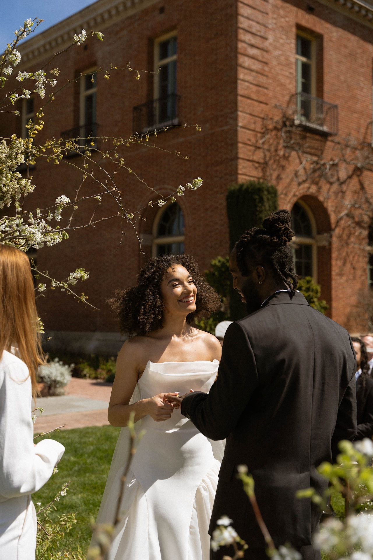 The bride and groom exchanging rings during their heartfelt outdoor ceremony at one of the most charming wedding estate venues.

