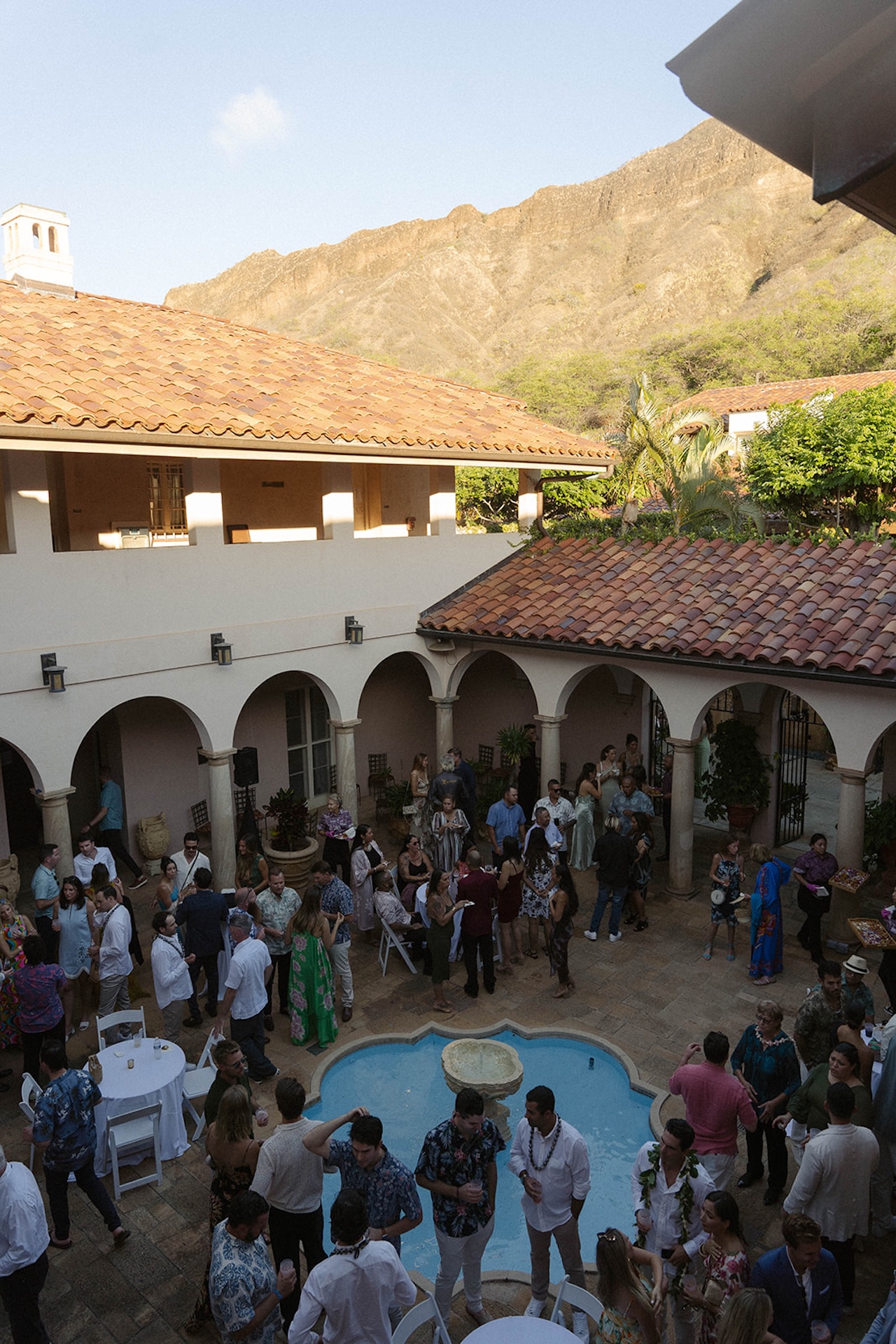Aerial view of a terracotta-roofed villa courtyard filled with guests — a dreamy scene from the best destination wedding locations.