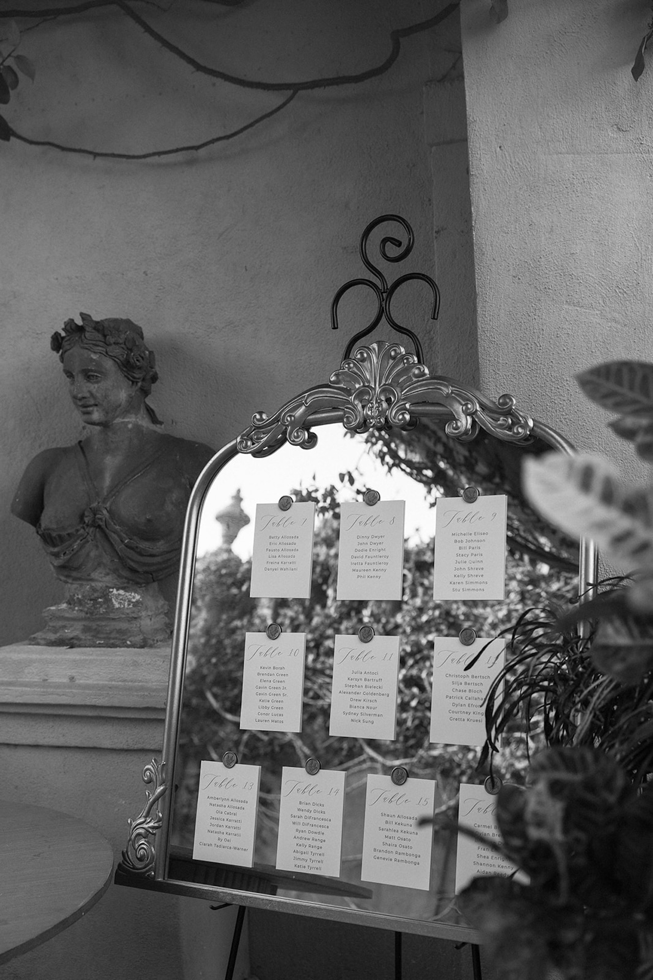 A mirror seating chart with handwritten names adds a refined touch to this intimate wedding aesthetic.