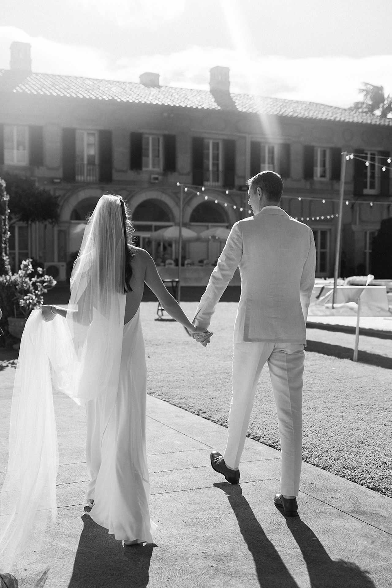 A romantic stroll through sunlit gardens, highlighting timeless style and coastal charm found in the best destination wedding locations.