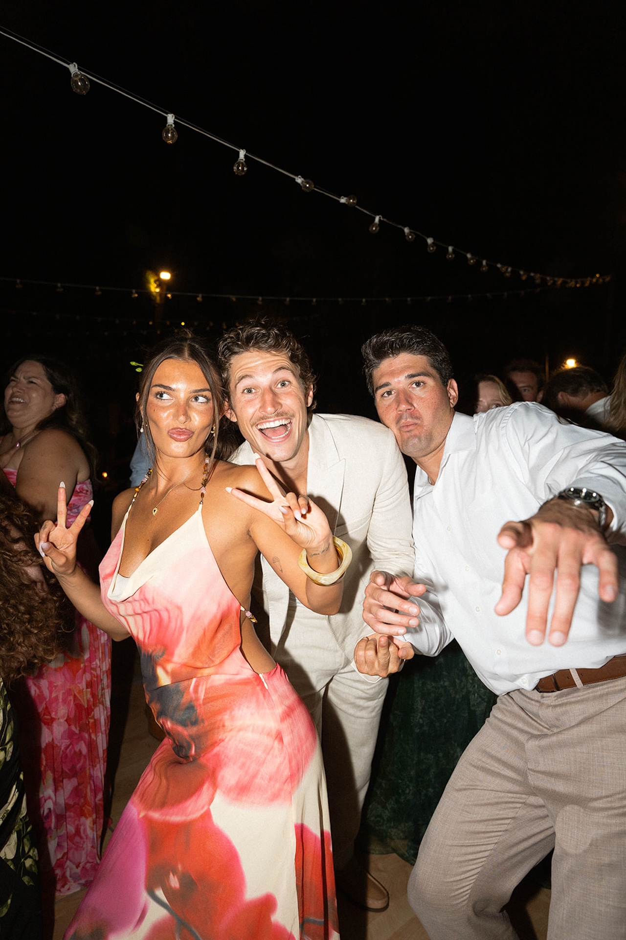 Guests pose playfully on the dance floor during the reception.