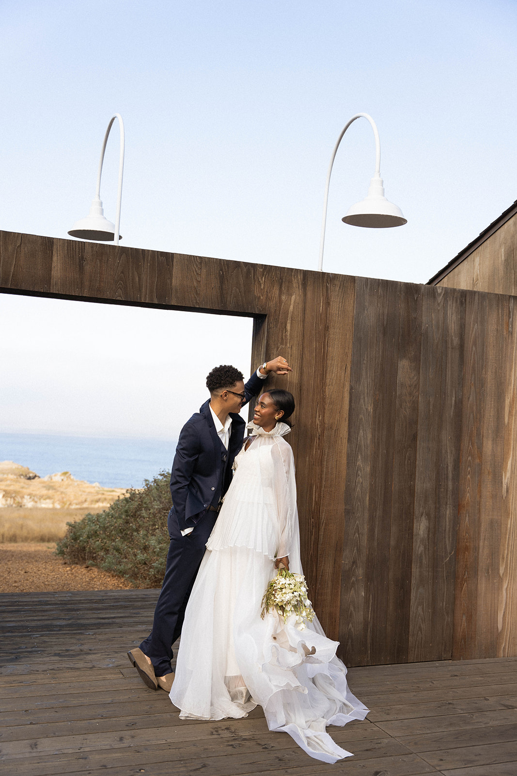 The bride and groom smiling at each other during their bride and groom portraits at their Sea Ranch Lodge Wedding