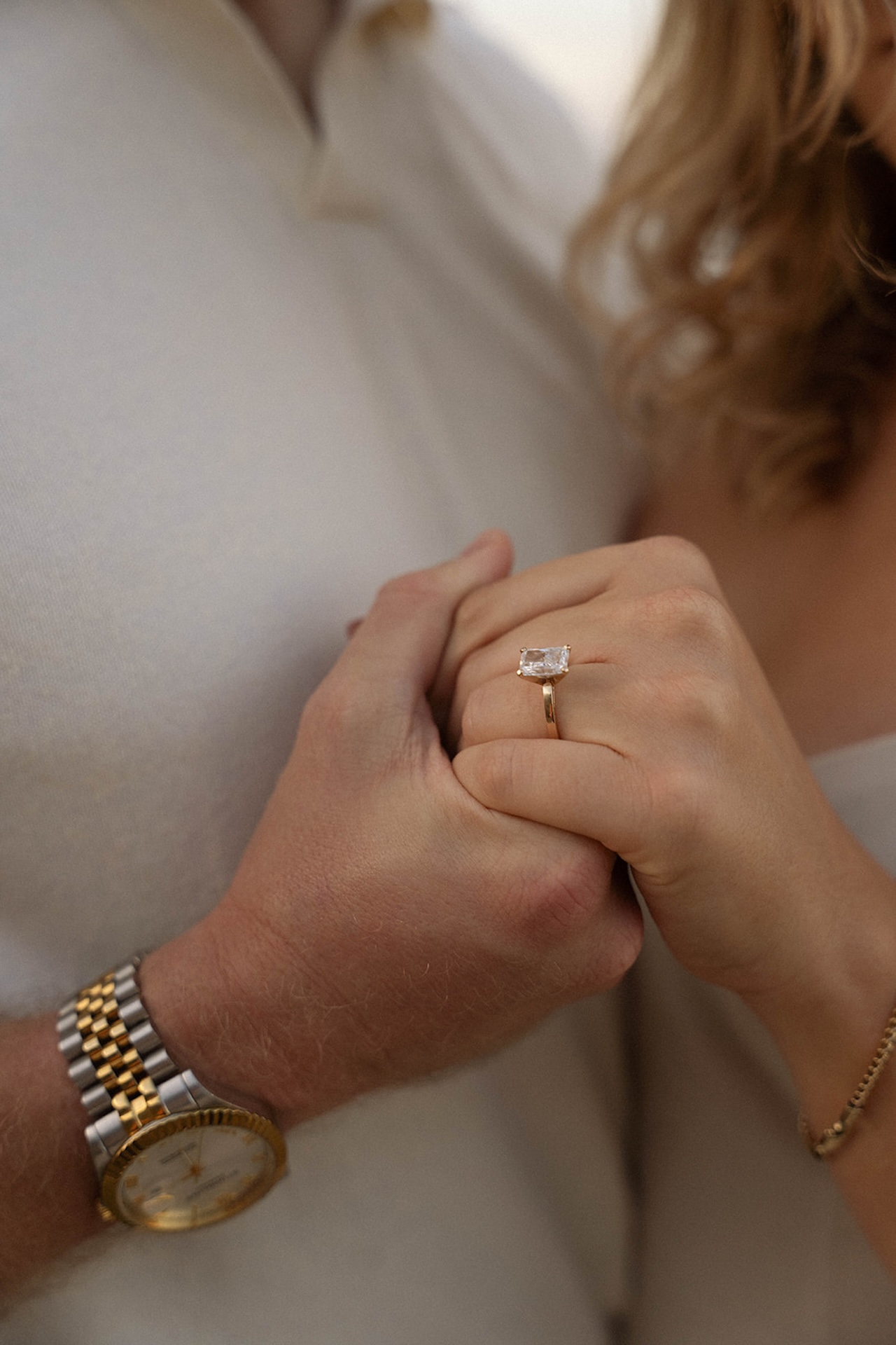 A close-up detail of the engagement ring as the couple holds hands, highlighting meaningful moments and personal connection.