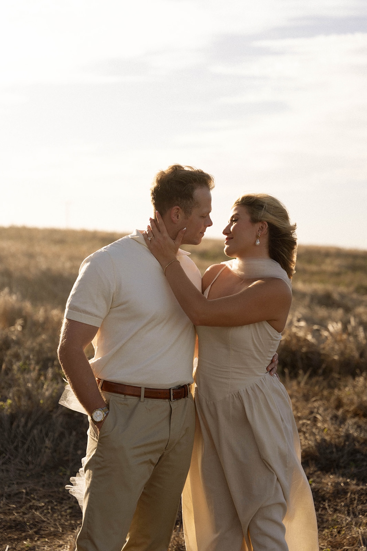 A close, intimate moment with the couple facing each other at golden hour, showcasing timeless ideas for engagement photos on oahu with soft light.
